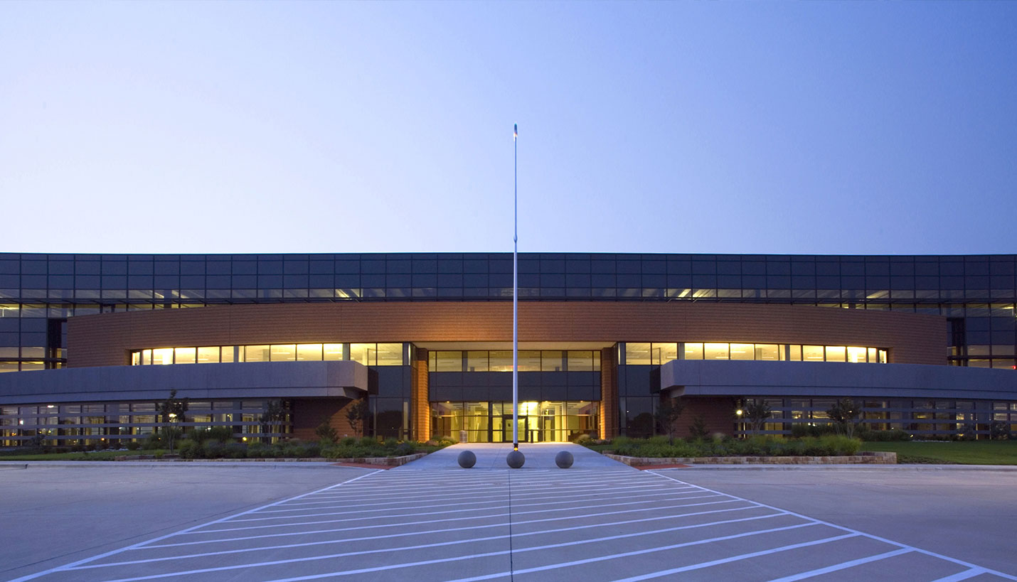 Evening view of front of Texas Instruments building in Richardson, Texas.